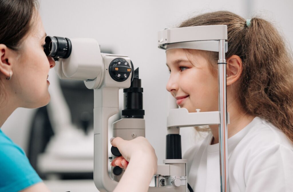 A child gets their eyes examined by an eye doctor.