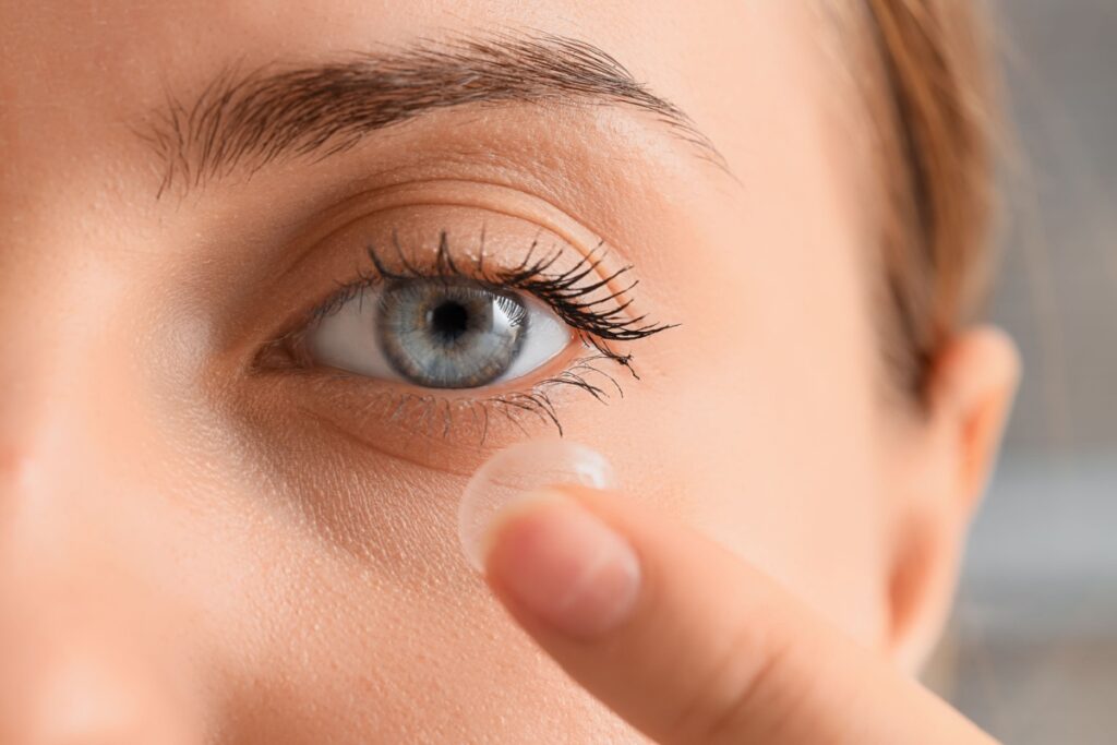 Woman putting in contact lens.